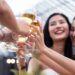 Group of Asian woman friends drinking beer alcohol having party at rooftop restaurant