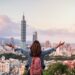 Young woman traveler looking beautiful cityscape at sunset in Taipei, Travel lifestyle concept